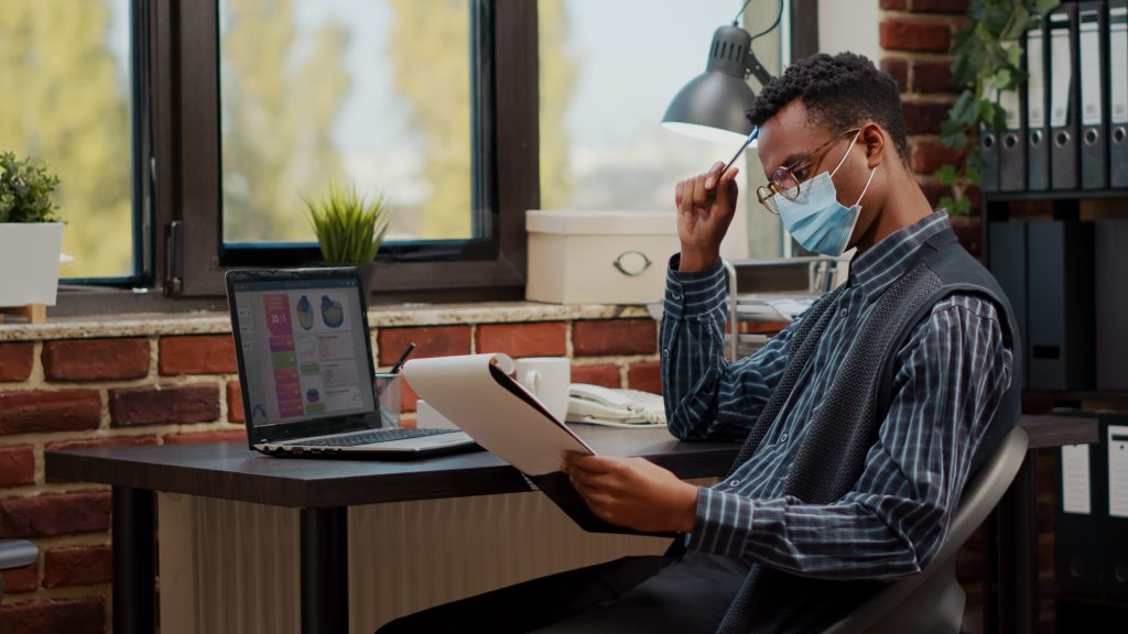 African american employee working on financial report in startup offce